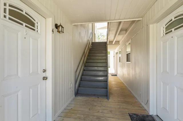 a view of a hallway with wooden floor and entryway