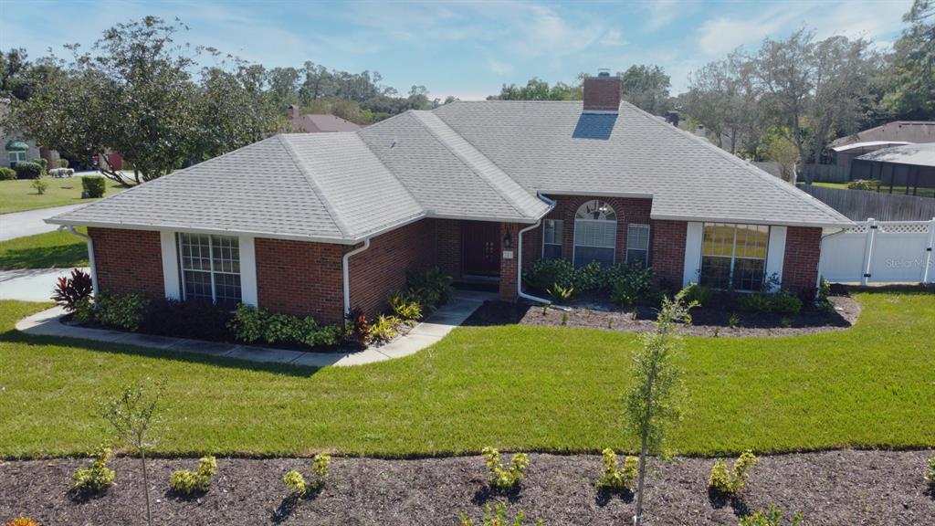 a aerial view of a house with a yard patio and fire pit