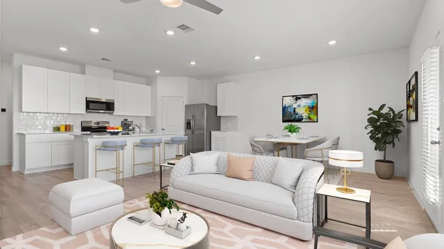 a living room with furniture and a dining table with kitchen view