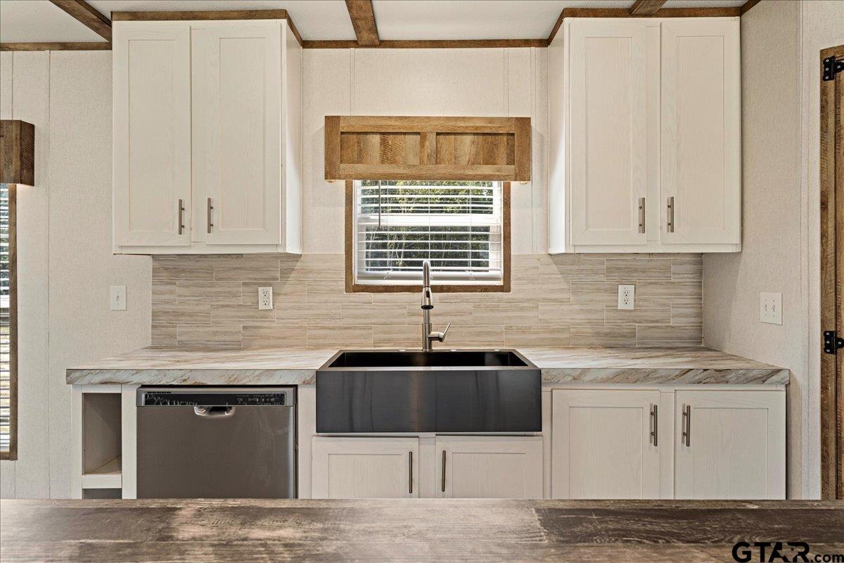 4776 County Road 4509 Athens, TX 75752 - Photo 13 of 25 a kitchen with granite countertop a sink stove and cabinets