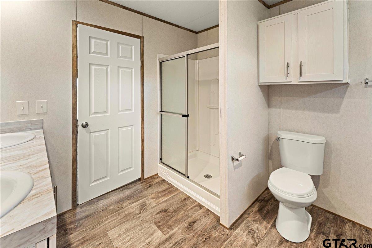 4776 County Road 4509 Athens, TX 75752 - Photo 16 of 25 a bathroom with a toilet and a shower