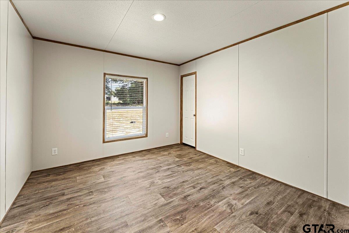 4776 County Road 4509 Athens, TX 75752 - Photo 18 of 25 a view of an empty room with wooden floor and a window