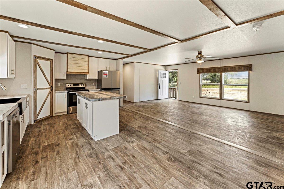 4776 County Road 4509 Athens, TX 75752 - Photo 2 of 25 a view of a kitchen with stove and wooden floor