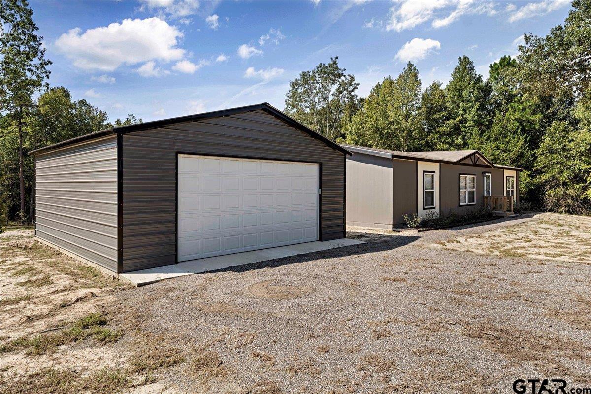 4776 County Road 4509 Athens, TX 75752 - Photo 4 of 25 a front view of a house with a yard and garage