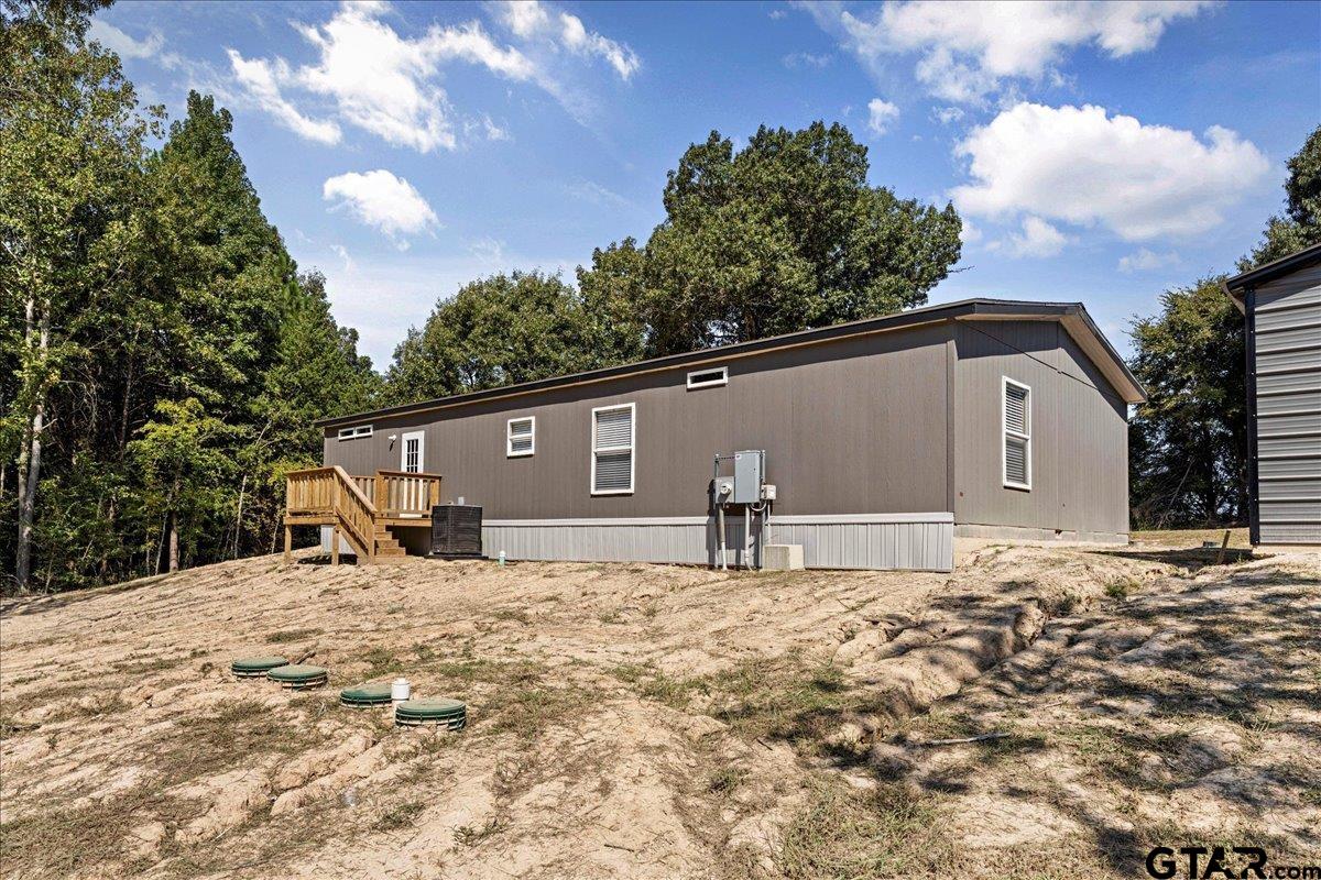 4776 County Road 4509 Athens, TX 75752 - Photo 5 of 25 a backyard of a house with large trees