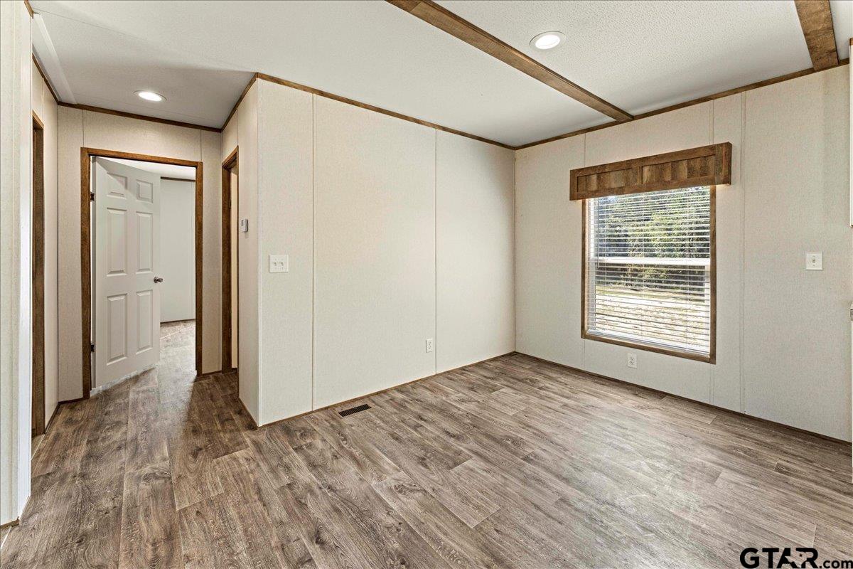 4776 County Road 4509 Athens, TX 75752 - Photo 10 of 25 a view of an empty room with wooden floor and a window