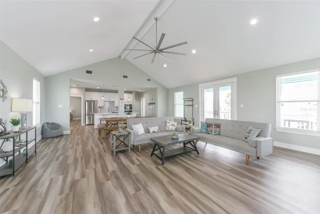 a living room with furniture and a wooden floor