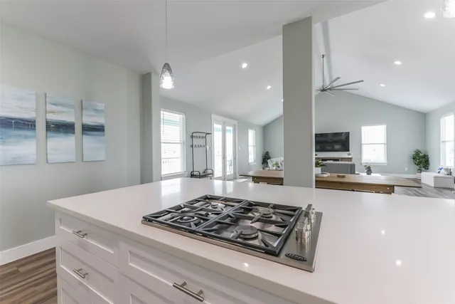 a kitchen with kitchen island a sink stainless steel appliances and cabinets