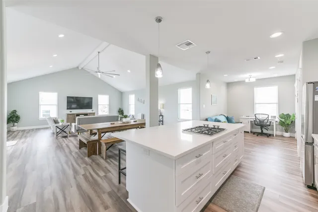a large kitchen with a table and chairs