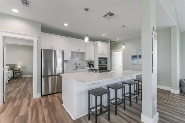 a kitchen with refrigerator and a table
