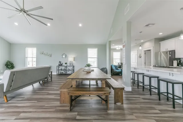 a living room with furniture a wooden floor and a sink