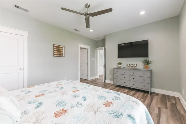 a bedroom with a bed and flat screen tv