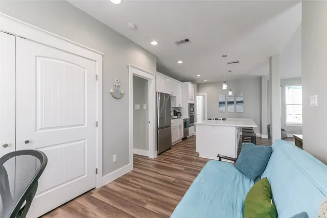 a open kitchen with white cabinets and stainless steel appliances
