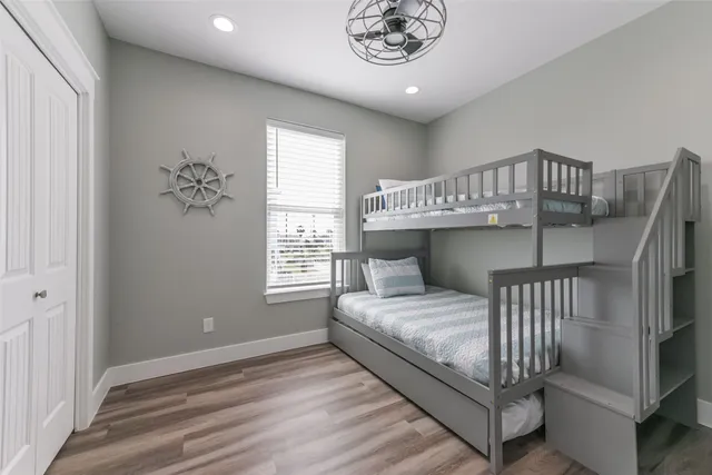 a bedroom with a bed next to a window