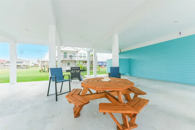 a room with pool table and chairs