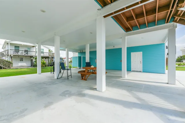 a view of a house with a patio and a yard
