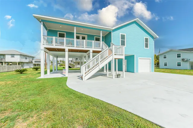 a view of a house with a yard and deck