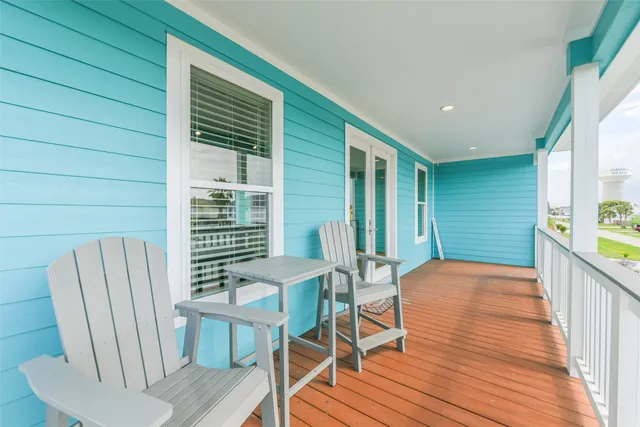 a view of a deck with table and chairs and wooden floor
