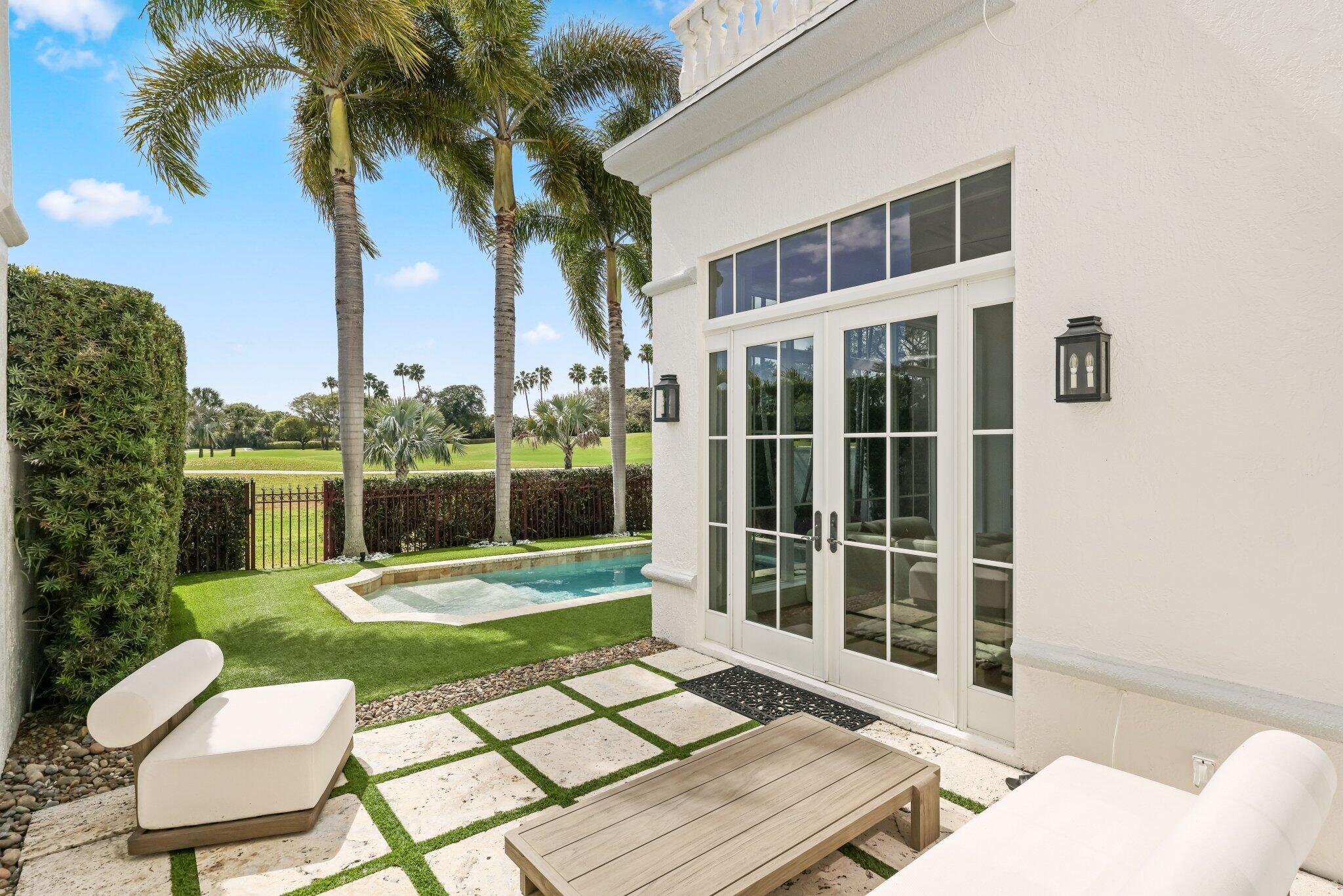 340 East Royal Palm Road Boca Raton, FL 33432 - Photo 53 of 59 a view of a chairs and tables in the back yard of a house
