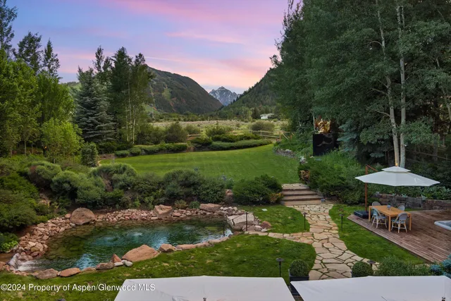 a living room with fireplace furniture and a flat screen tv