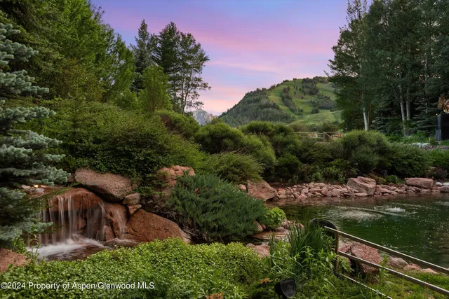 a living room with fireplace furniture and a large window