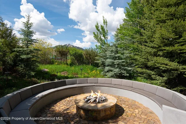 a dining room with furniture a chandelier and a rug