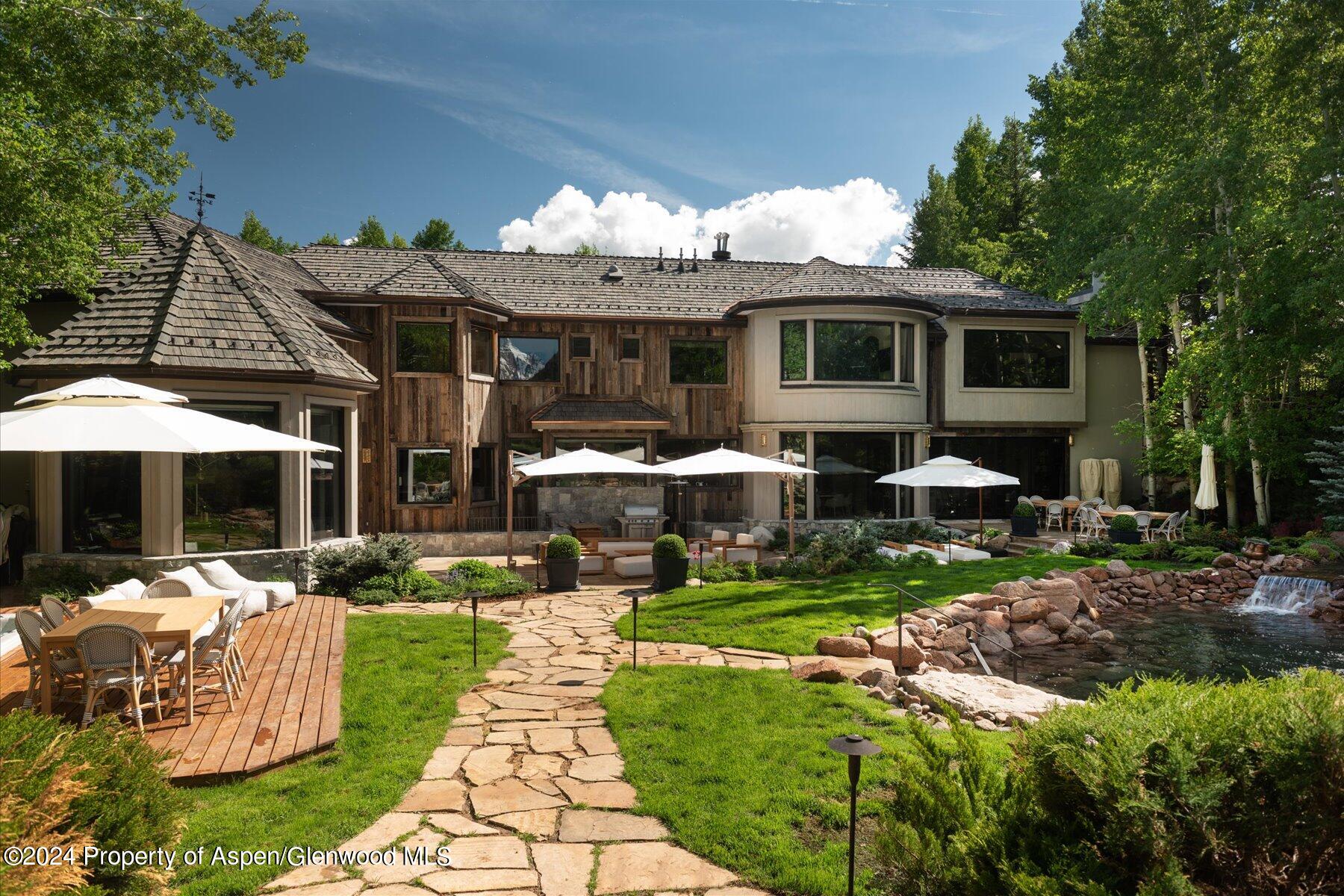 73 Hideaway Lane Aspen, CO 81611 - Photo 4 of 100 a front view of a house with garden