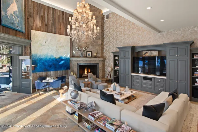 a living room with furniture and a floor to ceiling window