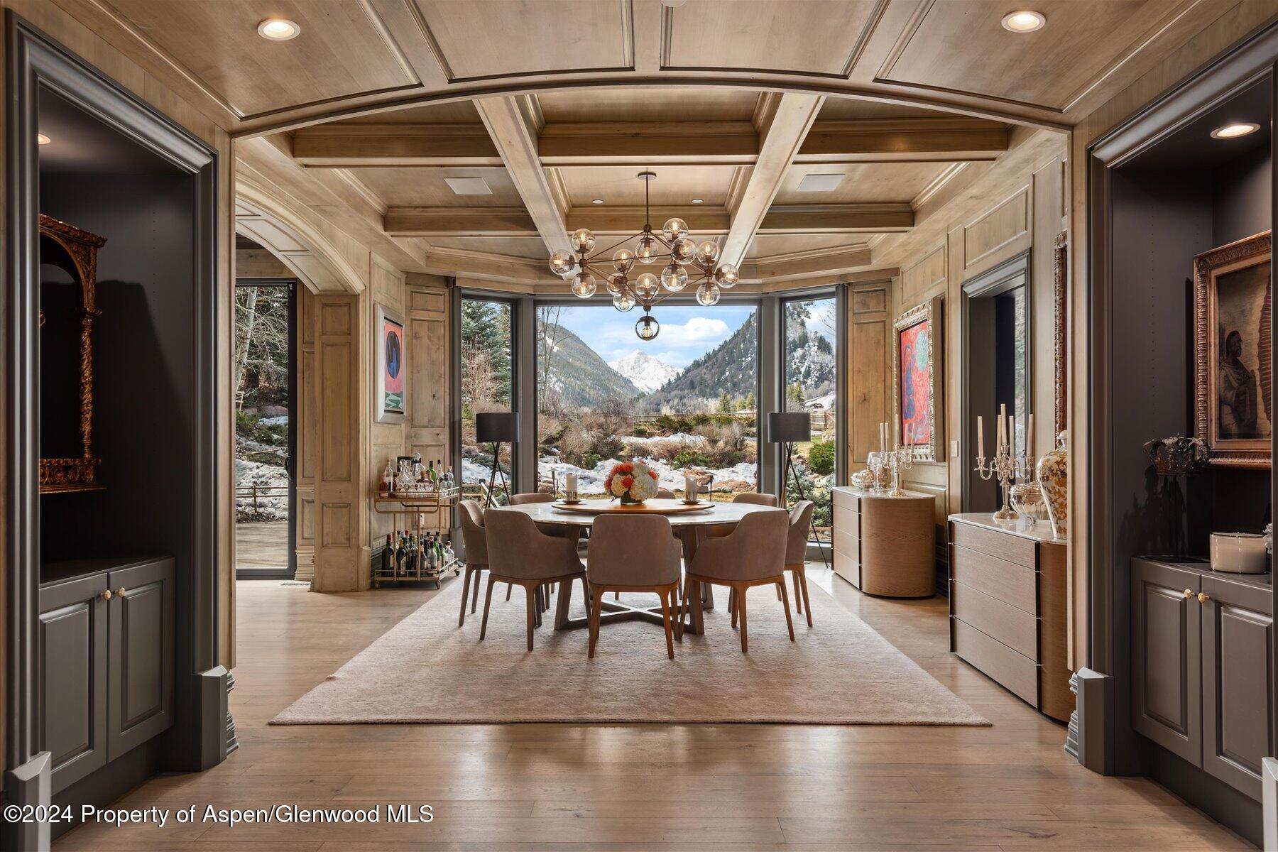 73 Hideaway Lane Aspen, CO 81611 - Photo 68 of 100 a view of a dining room with furniture large windows and wooden floor