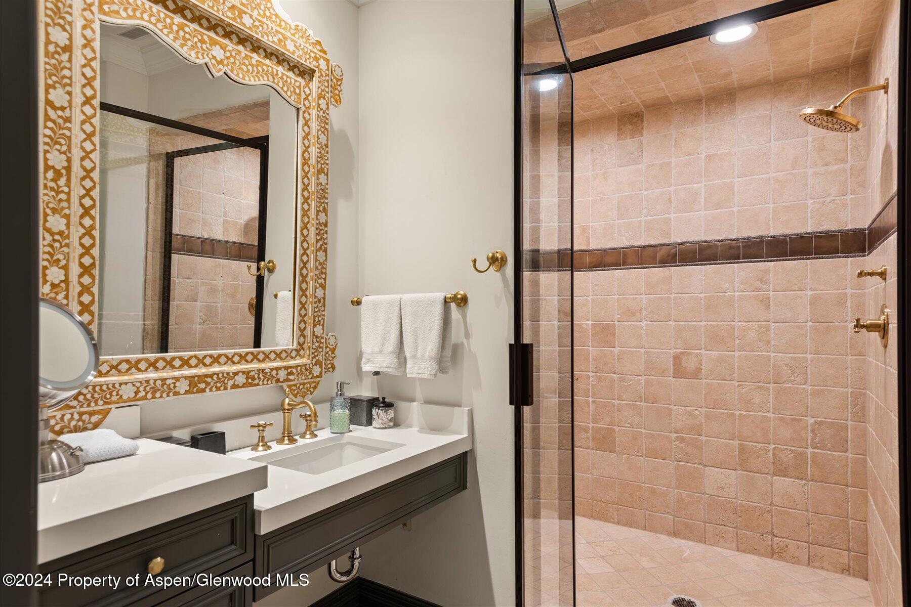 73 Hideaway Lane Aspen, CO 81611 - Photo 73 of 100 a bathroom with a granite countertop sink a mirror and a shower