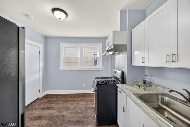 a kitchen that has a sink and a stove
