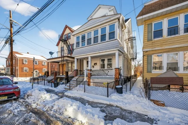 a view of a building with furniture and sitting area