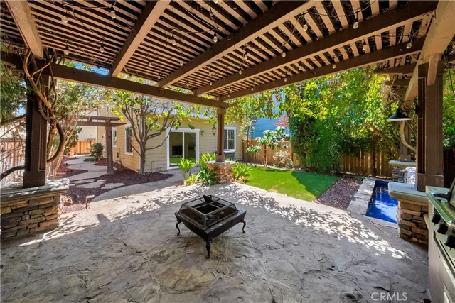 a view of a patio with a table chairs and a yard
