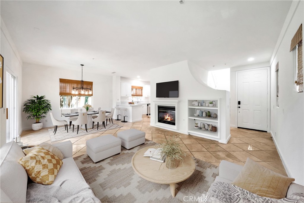 5 Flowerdale Ladera Ranch, CA 92694 - Photo 4 of 22 a living room with furniture a fireplace and a flat screen tv
