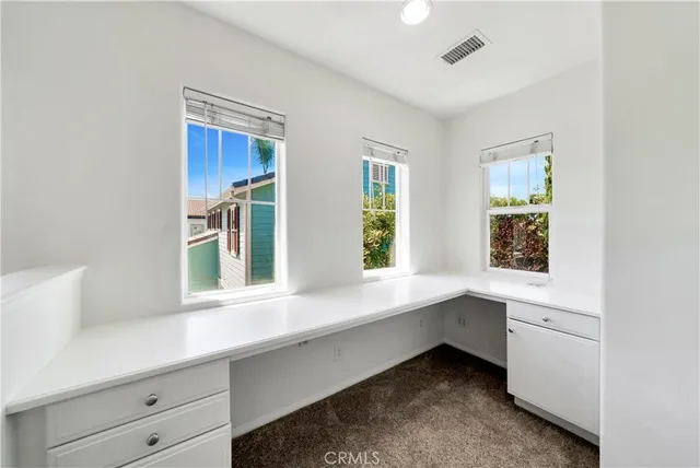 a hallway with a sink and cabinets