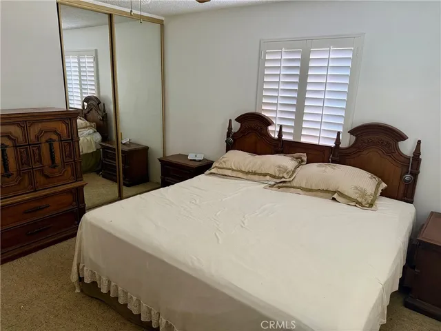 a bedroom with bed and a window