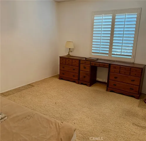 a room with a dresser and a window