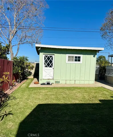 a view of a back yard with a wooden fence