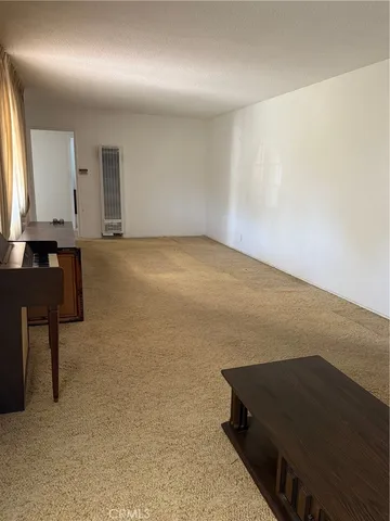a view of room and hall with wooden floor