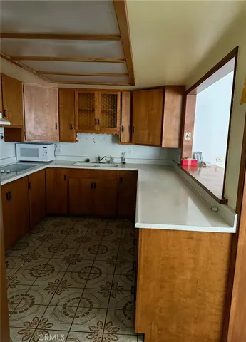 a view of a kitchen with a sink and a large window