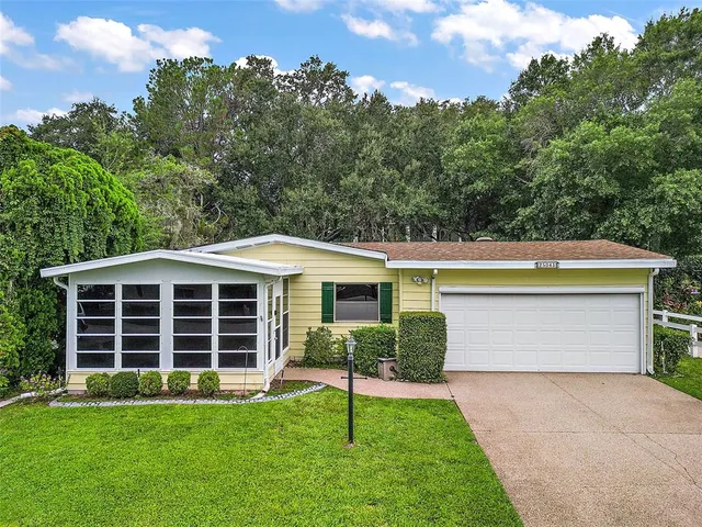 a view of a house with a backyard