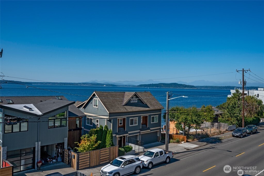 4226 Beach Drive Southwest, Unit 303 Seattle, WA 98116 - Photo 1 of 21 a front view of a house with garden