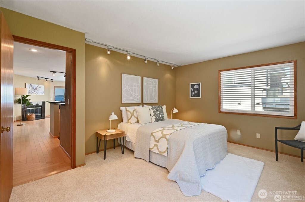 4226 Beach Drive Southwest, Unit 303 Seattle, WA 98116 - Photo 11 of 21 a bedroom with a bed and a table in it