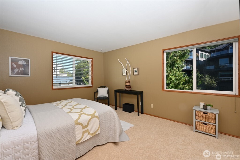 4226 Beach Drive Southwest, Unit 303 Seattle, WA 98116 - Photo 12 of 21 a bedroom with a bed and a window with outer view