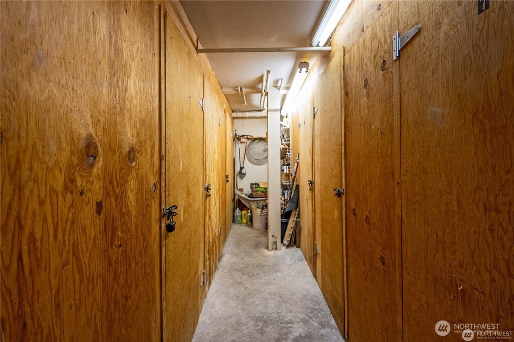 4226 Beach Drive Southwest, Unit 303 Seattle, WA 98116 - Photo 21 of 21 a view of a hallway with wooden walls