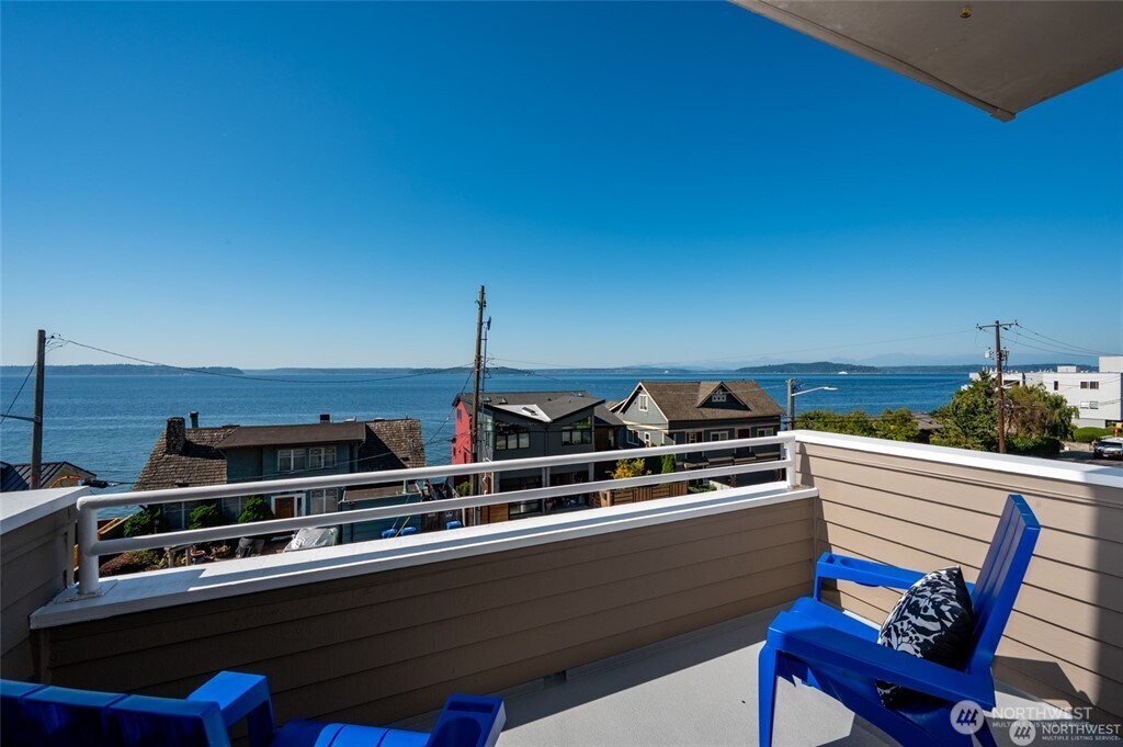 4226 Beach Drive Southwest, Unit 303 Seattle, WA 98116 - Photo 3 of 21 a view of a chairs and table on the terrace