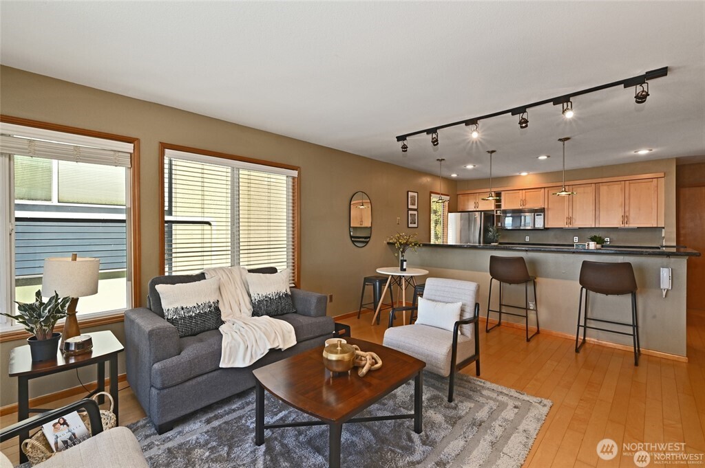 4226 Beach Drive Southwest, Unit 303 Seattle, WA 98116 - Photo 6 of 21 a living room with furniture and kitchen view
