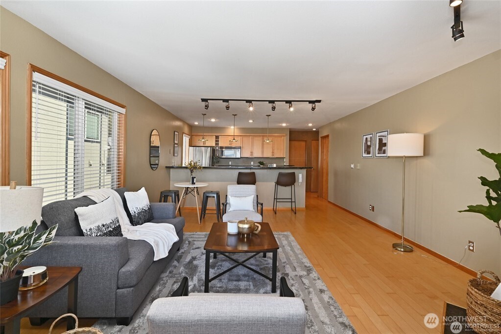 4226 Beach Drive Southwest, Unit 303 Seattle, WA 98116 - Photo 9 of 21 a living room with furniture and a large window
