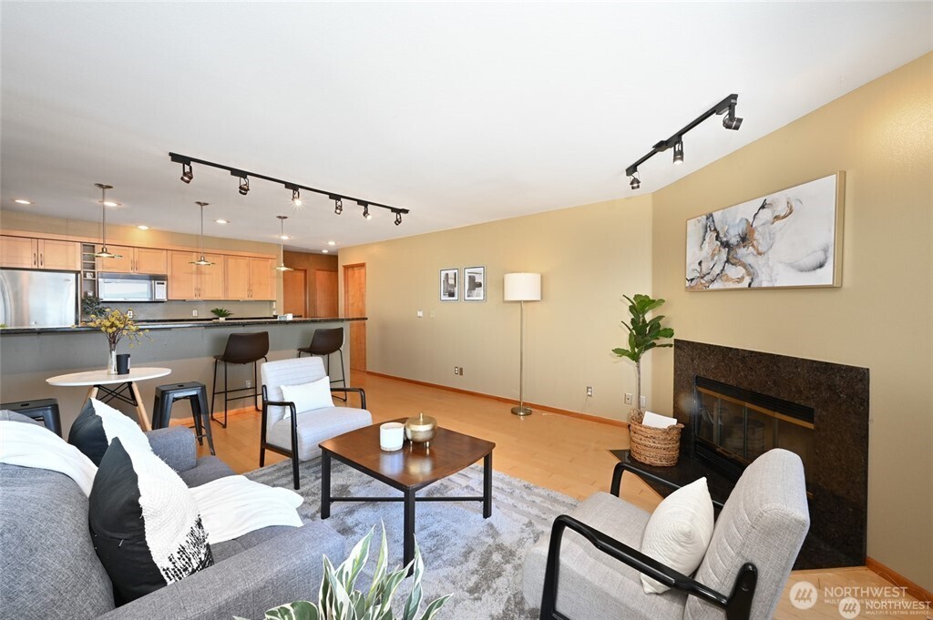 4226 Beach Drive Southwest, Unit 303 Seattle, WA 98116 - Photo 10 of 21 a living room with furniture and a wooden floor