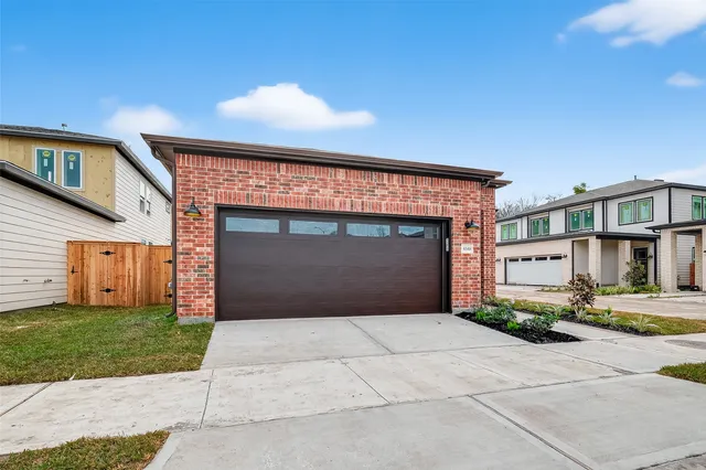 a front view of a house with a garden and entryway